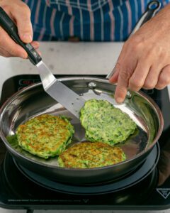 Turning the fritters in the pan with a spatula