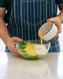 Ingredients for making fritters in a mixing bowl