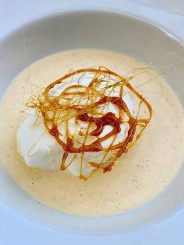 poached egg white pillows floating in vanilla sauce