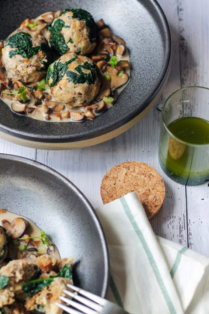 German bread dumplings with kale and mushroom sauce