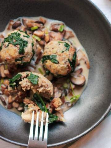 German bread dumplings with kale on a mushroom sauce