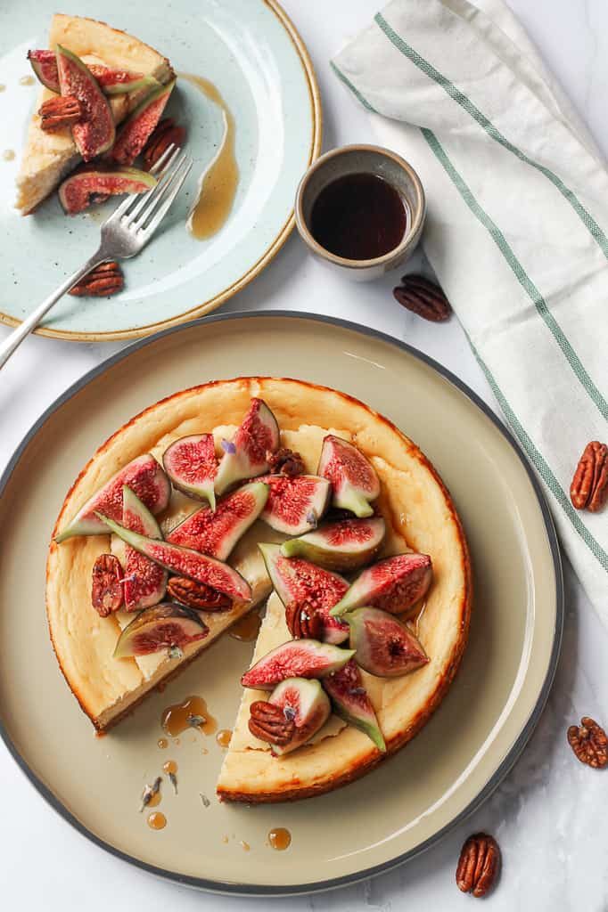 overhead shot of baked ricotta cheesecake with figs and pecan nuts