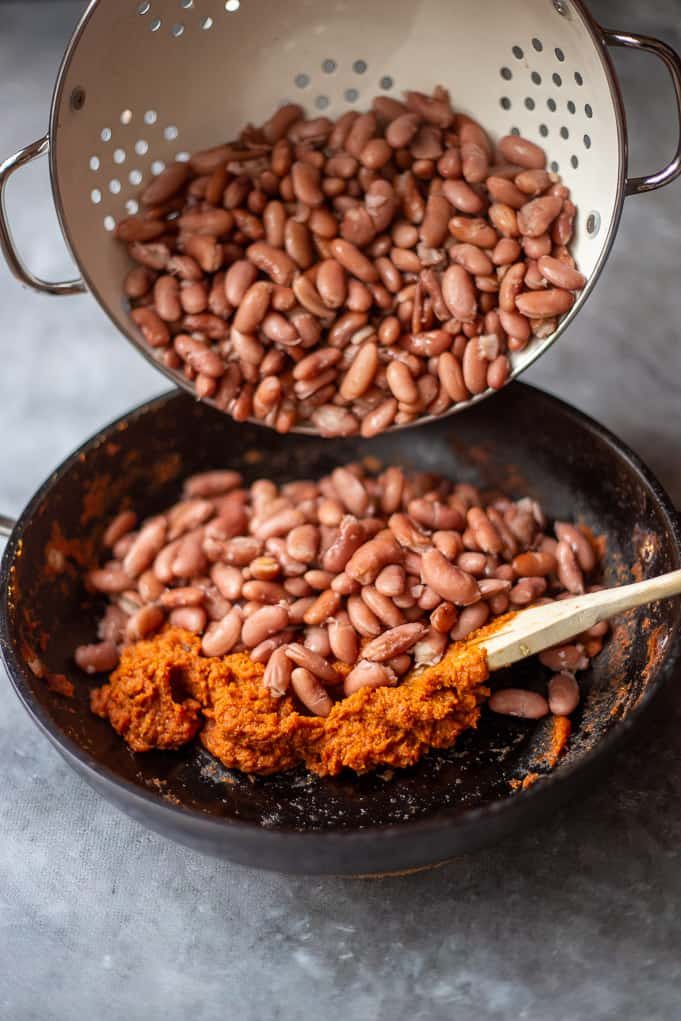 adding cooked rajma to tomato gravy