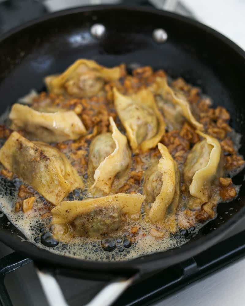 cooking agnolotti in a brown butter sauce