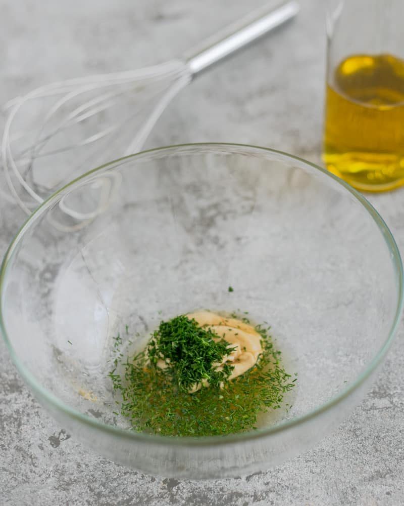 Mustard and dill sauce ingredients in a glass bowl