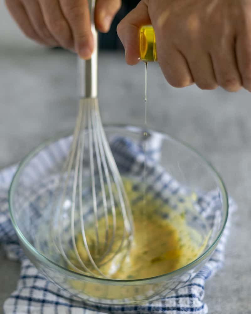 Drizzling olive oil into emulsion