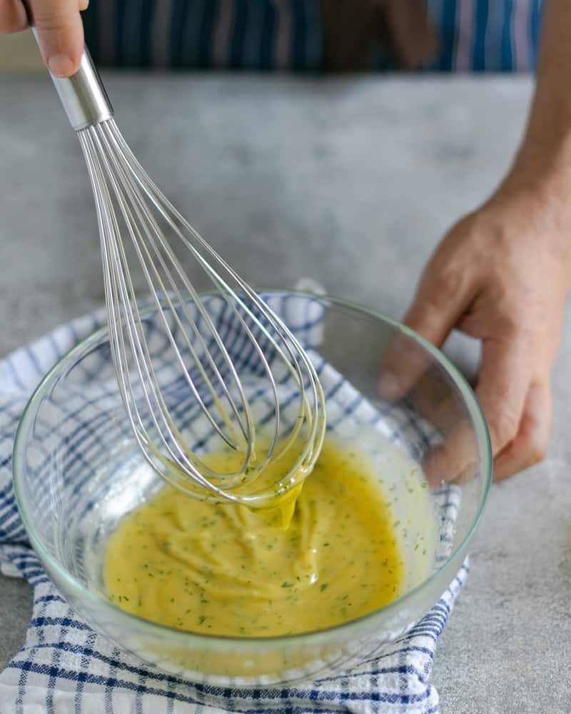 Showing consistency of whisked emulsion in glass bowl