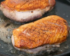 Pan fried duck breasts turned in a hot pan