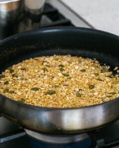 Toasting dukkah ingredients in a hot pan