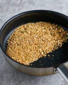Toasting dukkah ingredients in a hot pan