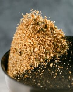 Dukkah ingredients tossed in a pan