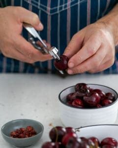 Pitting a cherry with a cherry pitter
