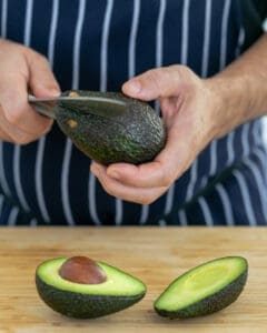 Avocado being cut in two halves