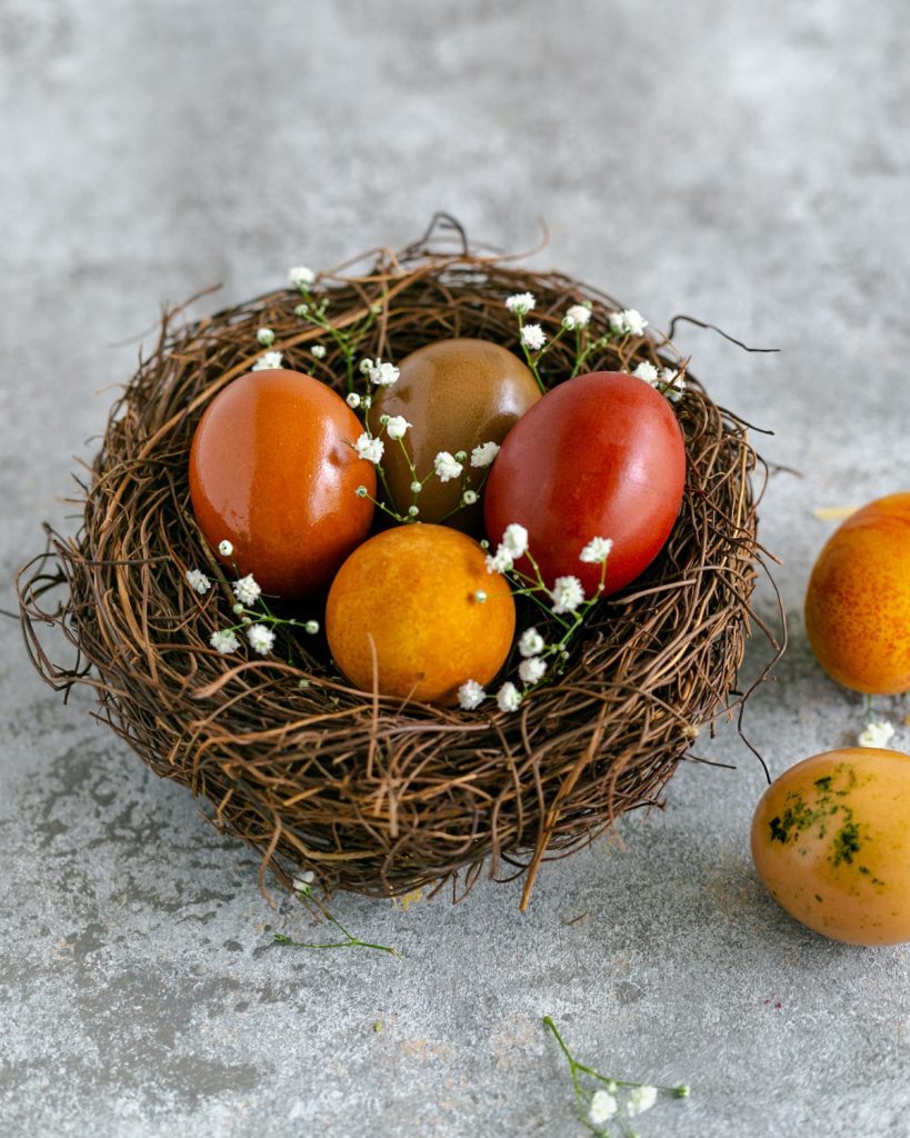 Colored eggs in a decorative nest