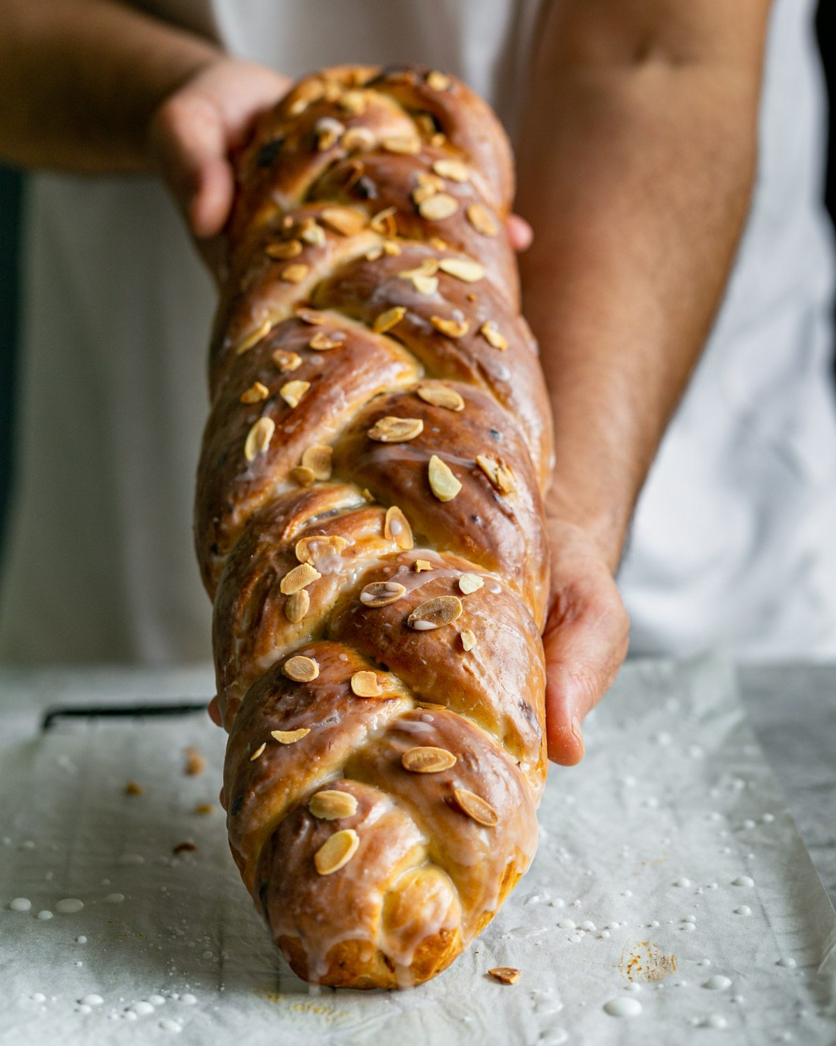 Holding Freshly baked Easter Zopf in hands