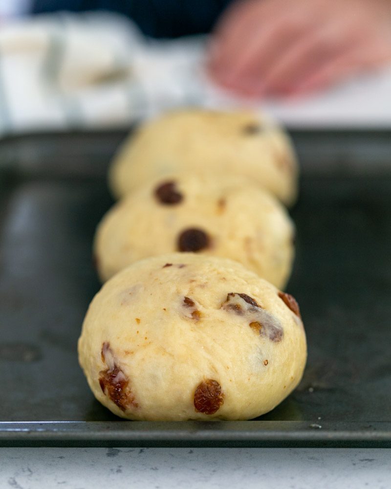 Three rolls of zopf dough on baking tray