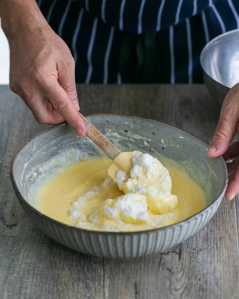 Folding in Whipped Egg Whites into Pancake Batter for Souffle-style pancakes with fresh ricotta and almonds