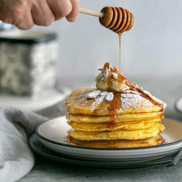 Souffle-Style Pancakes stacked with Maple syrup poured on top