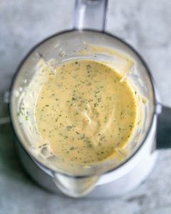 Overhead view inside the blender to show prepared garlic aioli