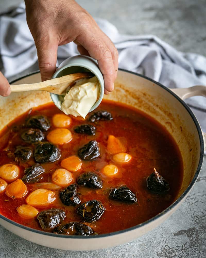 Creme fraiche being added to thicken the sauce