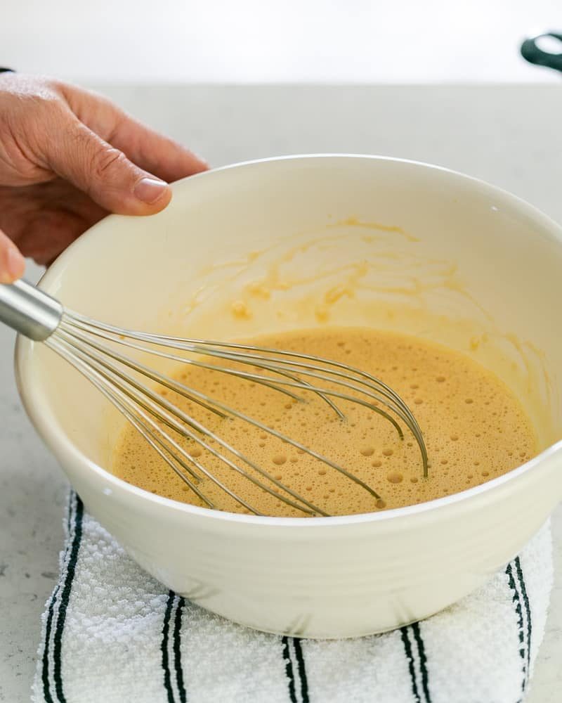 Lightly whisked eggs in a bowl for the creme caramel