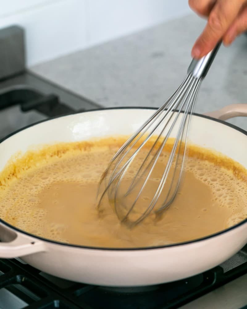 Continuously whisk the caramel and milk and cream mixture to avoid lumps