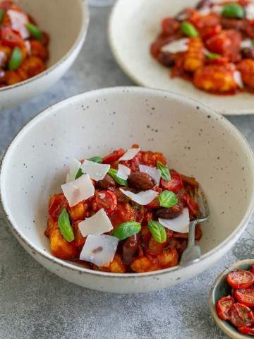 Bowl of Ricotta gnocchi with tomatoes and olives