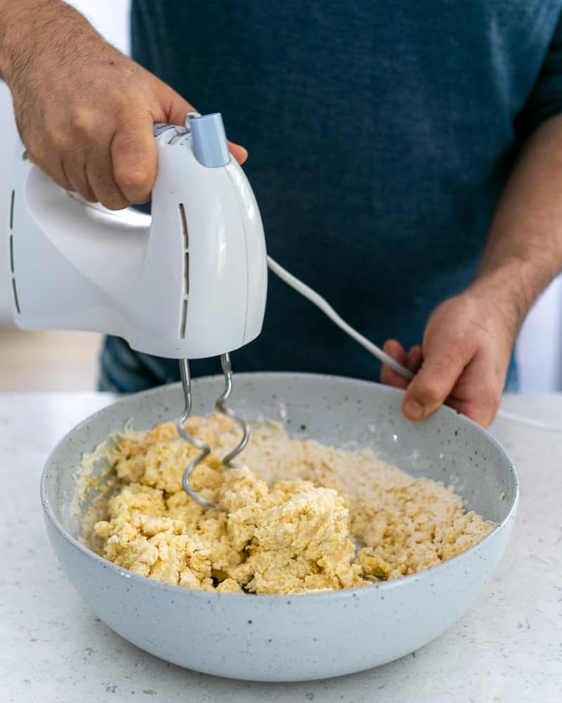 With a hand blender mixing gnocchi Dough 