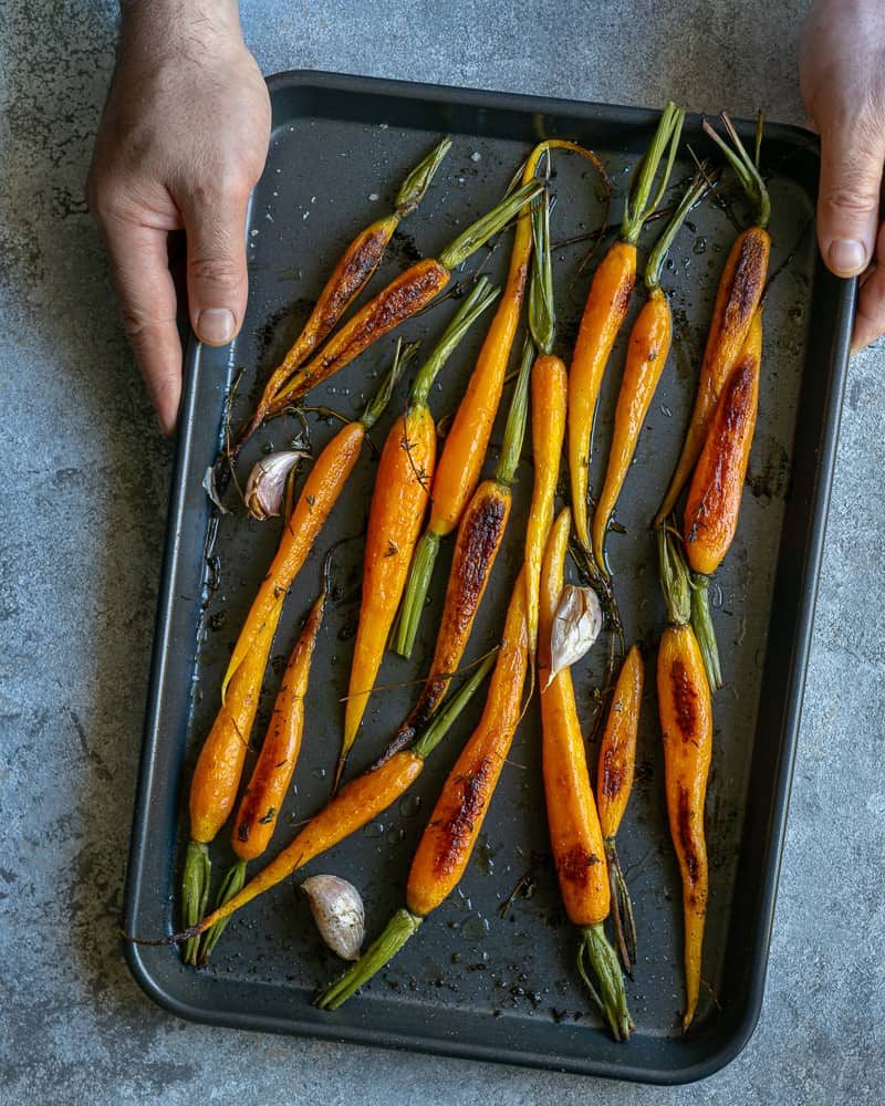 Oven roasted baby carrots on a baking tray