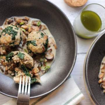 German bread dumplings with kale on a mushroom sauce