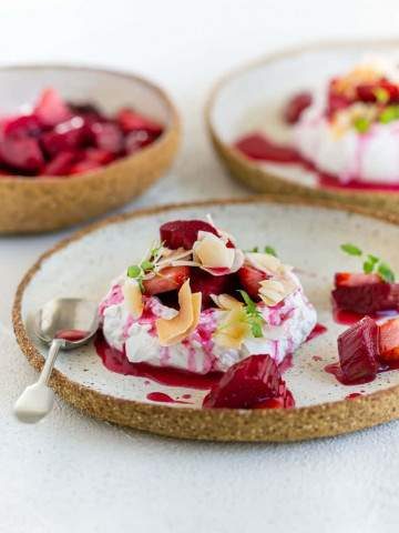 Poached Rhubarb with Strawberries with Coconut Chantilly dessert close up