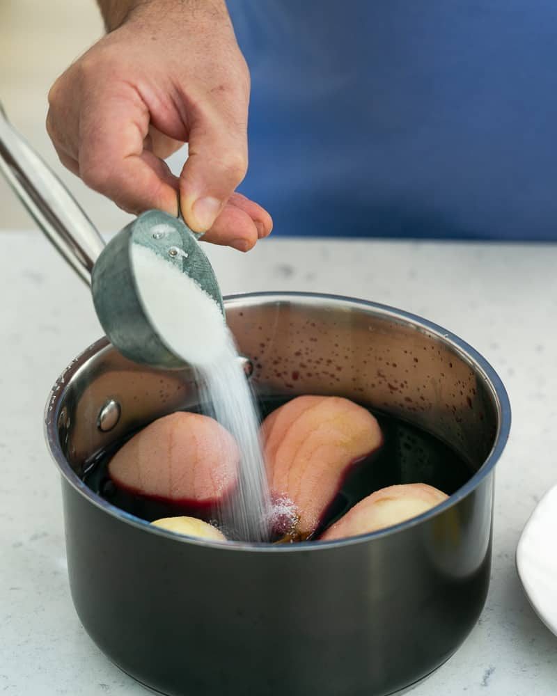 Add sugar to the pears in wine