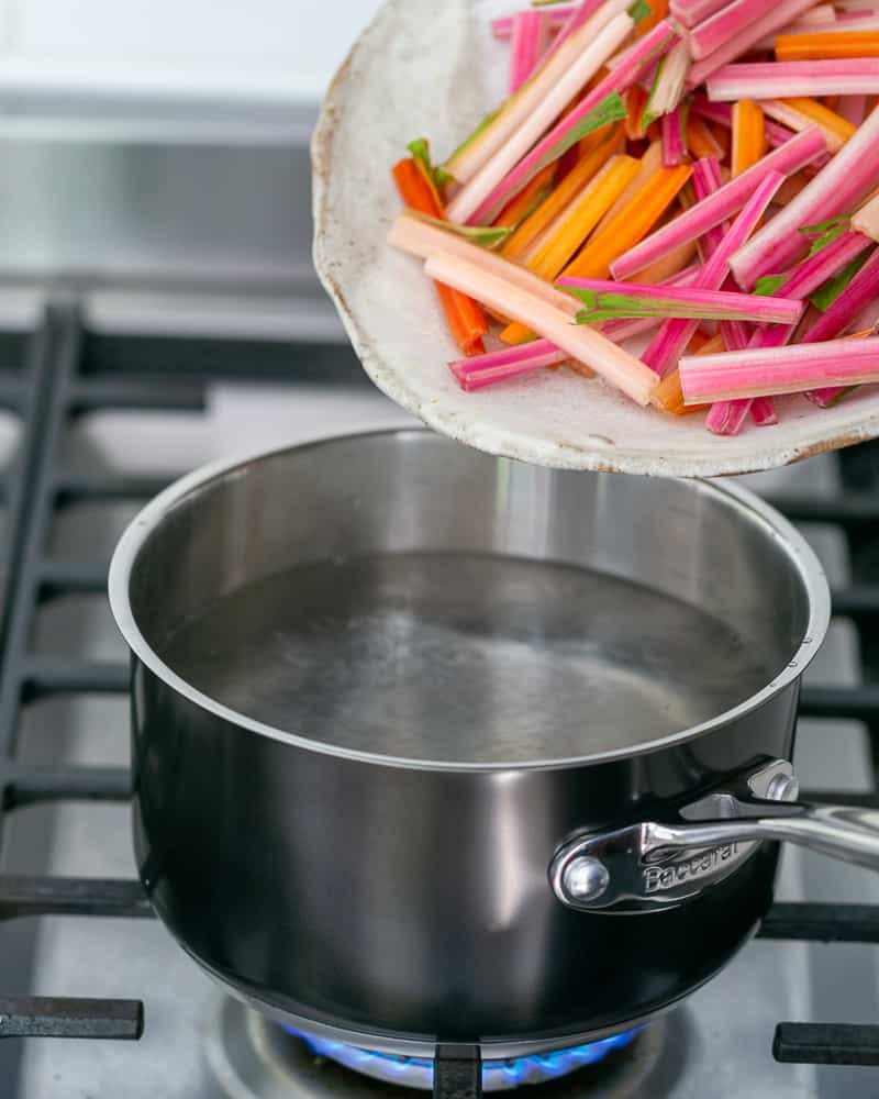 Blanching swiss chard stems in pot of boiling water