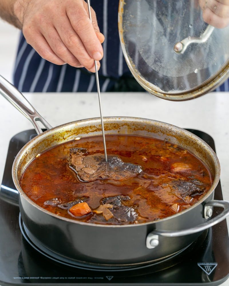 Using a skewer check if the beef cheek is cooked