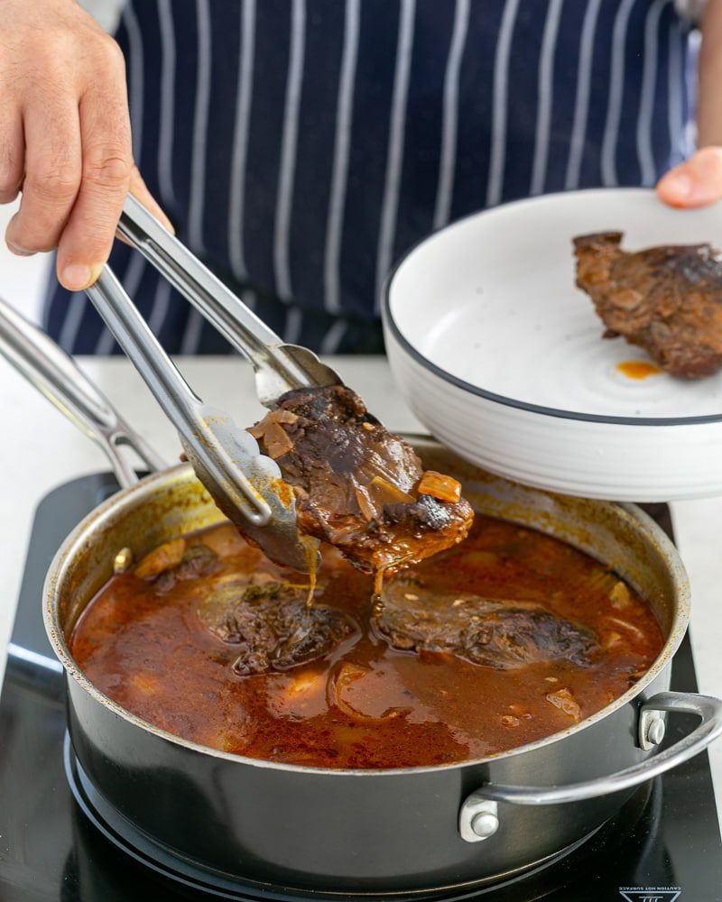 Cooked beef cheeks removed to cook jus further