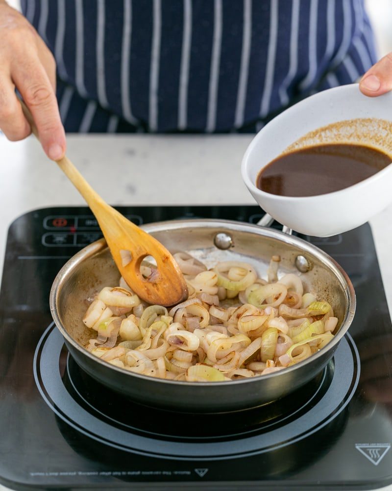 Adding the prepared jus to the caramelized shallots