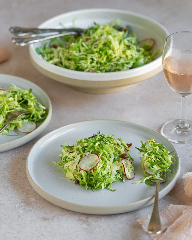 Brussels sprout slaw with raisins served as a side dish