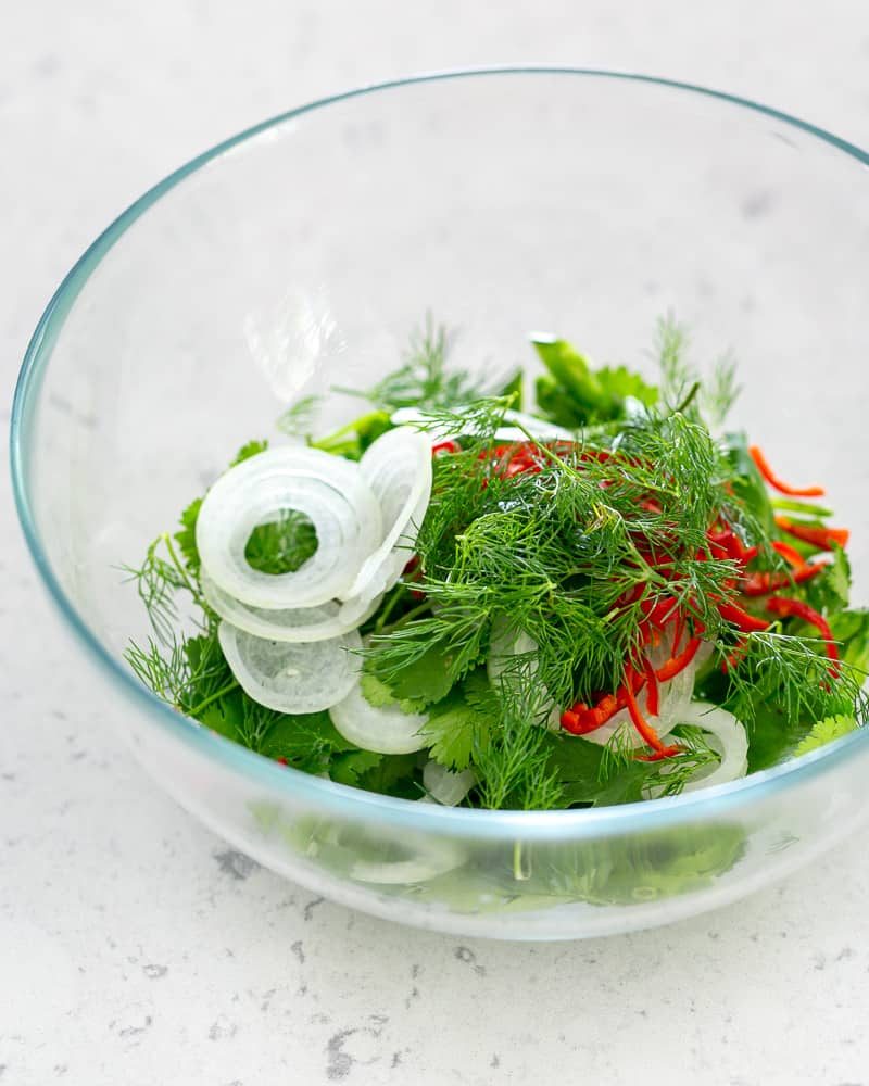 Fresh herbs soaked in cold water to keep them bright and crisp