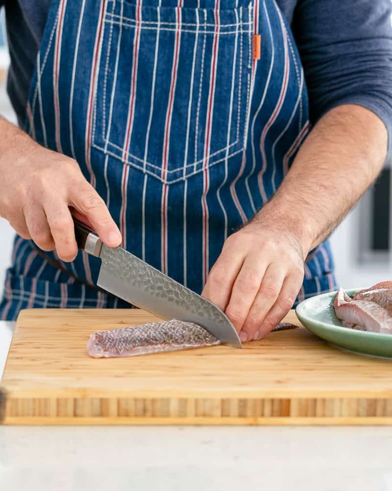 Snapper fillet cut into two for making seared red snapper 