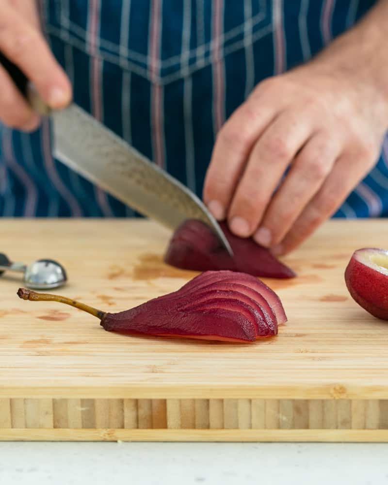 Pear cut in a fan shape to plate up spiced poached pears with mascarpone