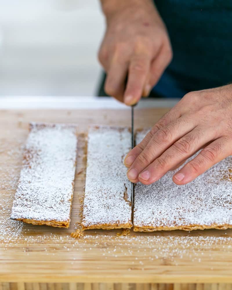 Cutting puff pastry in shards for Dulce de Leche Verrine with Banana and whipped Cream