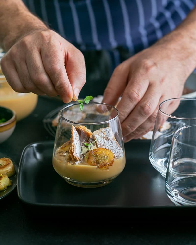 Garnishing Dulce de Leche Verrine with Banana and whipped Cream with Lemon Myrtle balm