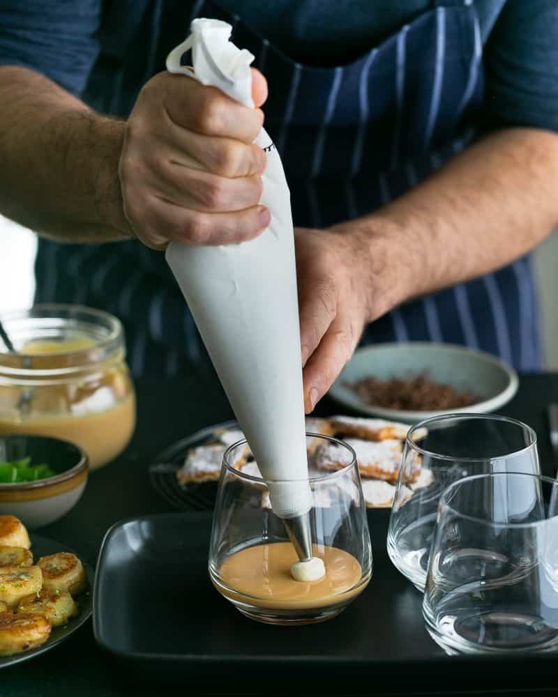 Piping Vanilla Whipped cream assembling Dulce de Leche Verrine with Banana and whipped Cream