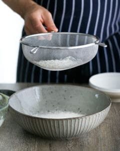 Sifting flour in a large bowl