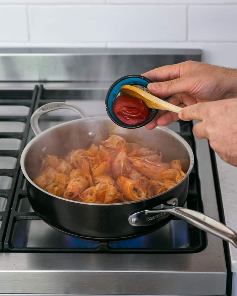 Tomato paste added to prawn shells to make stock