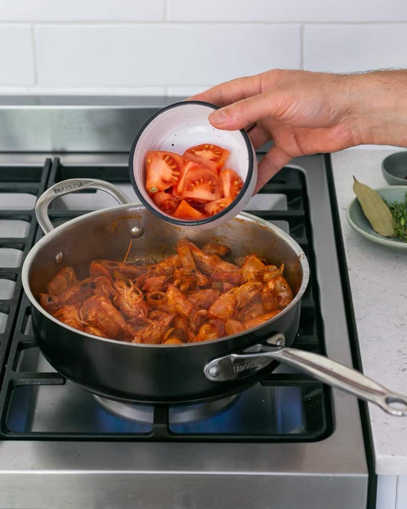 Tomato trimmings added to pan making prawn stock