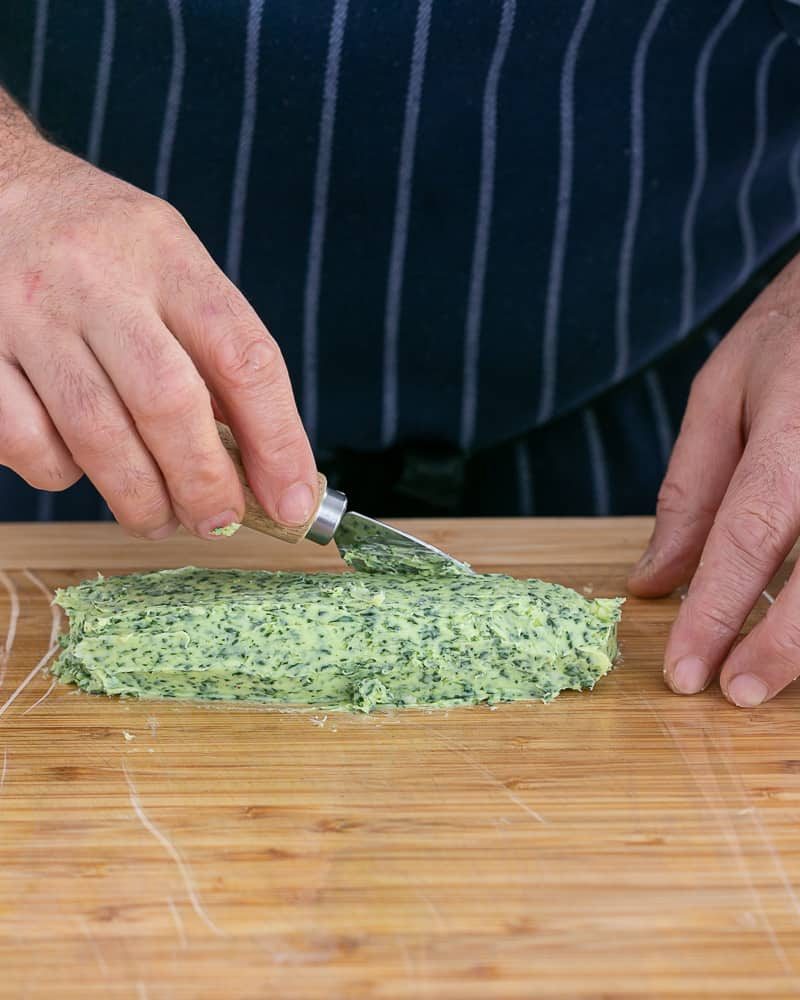 Soft garlic Herb butter transferred to cling film to roll into a butter log