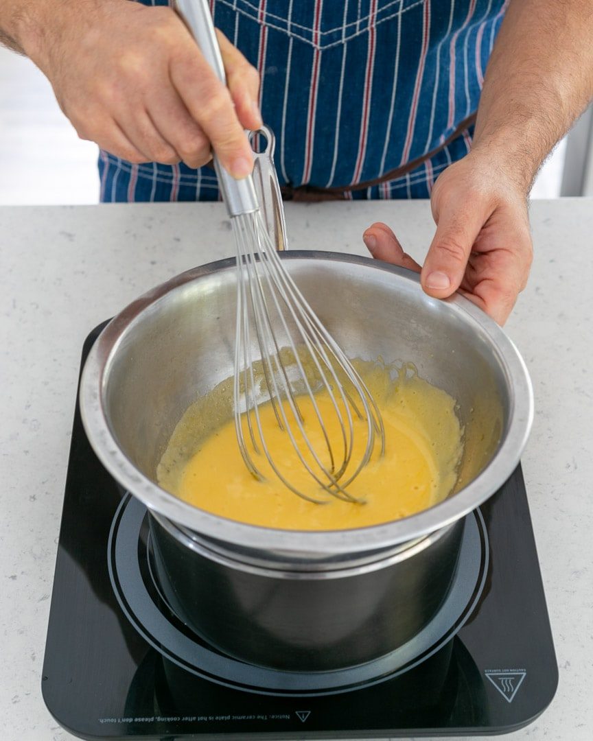 Whisking egg yolks over bain marie 