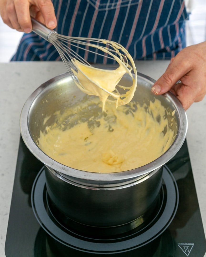 Checking Consistency of Hollandaise Sauce with a whisk