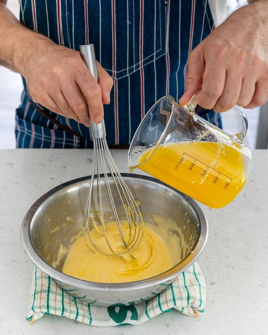 Adding clarified butter to egg yolk mix